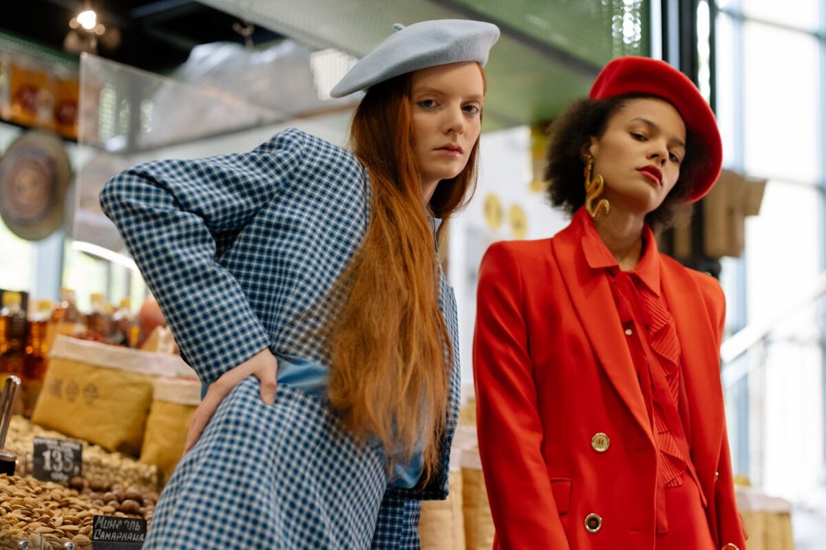 Service Two stylish women in blazers and berets posing elegantly in a market.